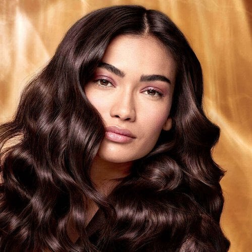 Extraordinary Oils Hero Image Model with long brown hair